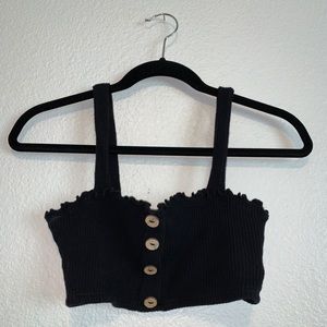 Short black crop top with buttons.